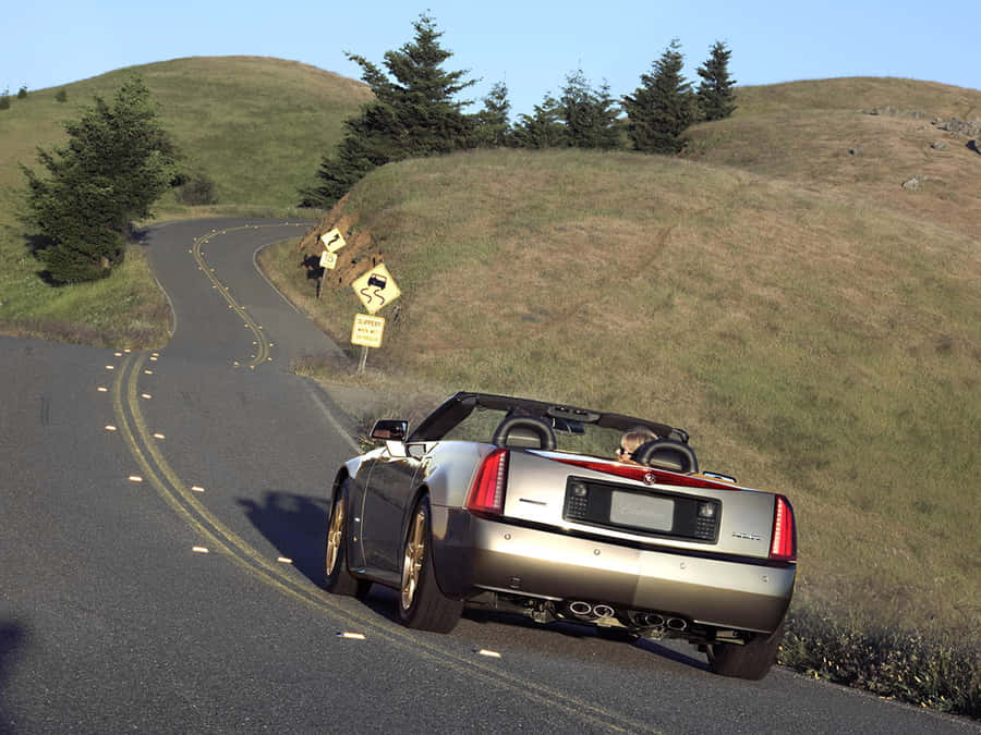 Sleek Cadillac Xlr Cruising The Streets Wallpaper