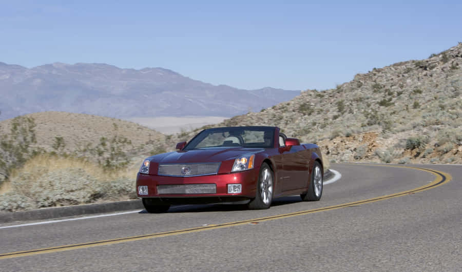 Sleek Cadillac Xlr On The Open Road Wallpaper