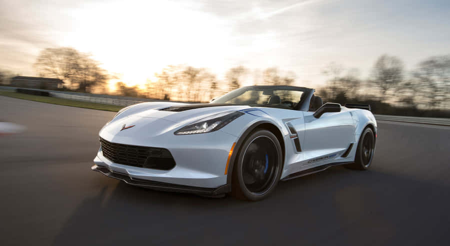 Sleek Chevrolet Corvette Grand Sport Cruising Down The Highway Wallpaper