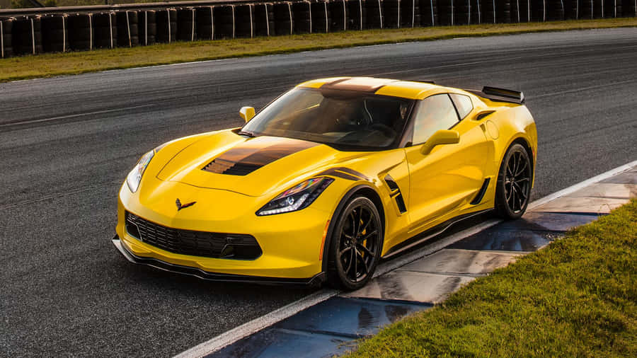 Sleek Chevrolet Corvette Grand Sport Cruising On The Highway Wallpaper