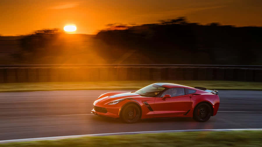 Sleek Chevrolet Corvette Grand Sport Gliding On The Highway Wallpaper