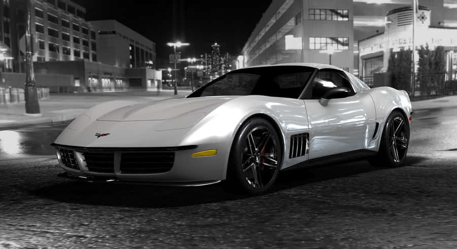 Sleek Chevrolet Corvette Stingray Cruising Down An Open Road Wallpaper