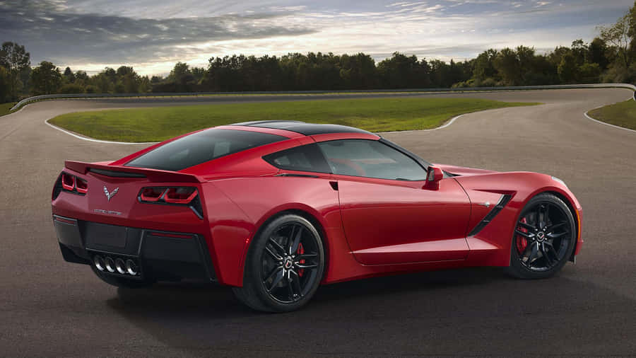 Sleek Chevrolet Corvette Stingray Cruising On The Road Wallpaper