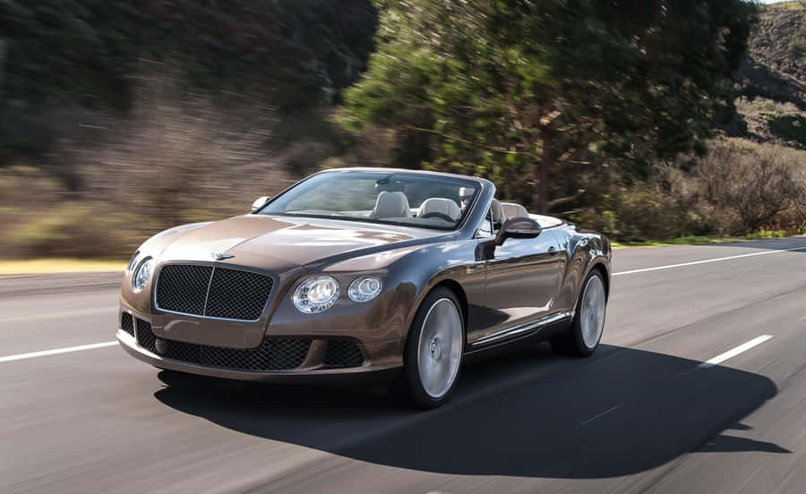 Sleek Convertible Car On Open Road Wallpaper