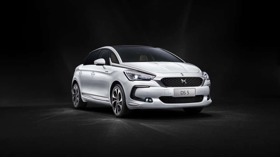 Sleek Ds Automobile On Scenic Road Wallpaper