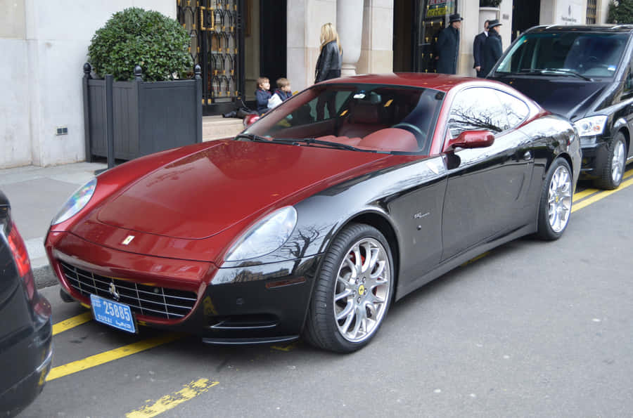 Sleek Ferrari 612 Scaglietti Cruising On A Scenic Highway Wallpaper