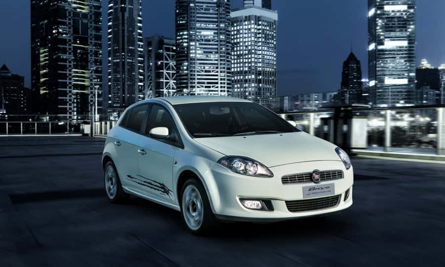 Sleek Fiat Bravo Driving On City Road Wallpaper