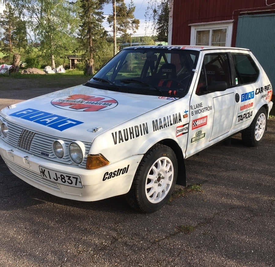 Sleek Fiat Ritmo In Vibrant City Setting Wallpaper