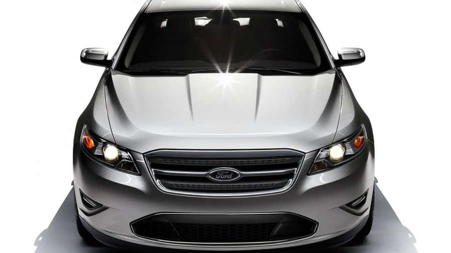 Sleek Ford Taurus Gliding On The Open Road Wallpaper