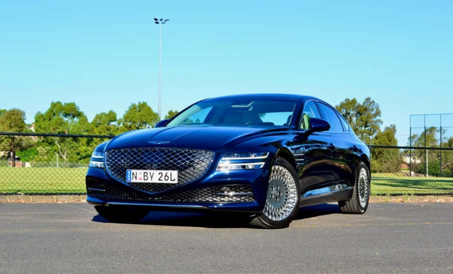 Sleek Genesis G70 Cruising On The Open Road Wallpaper