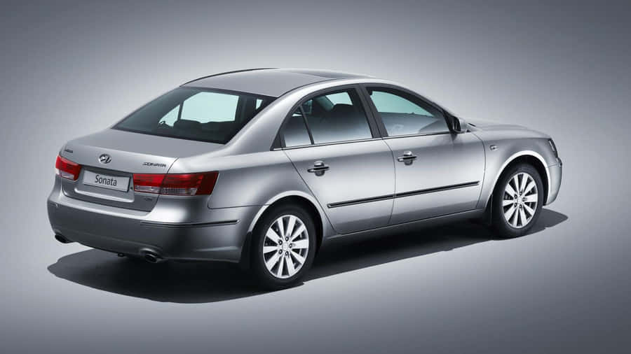 Sleek Hyundai Sonata Cruising On The Highway Wallpaper