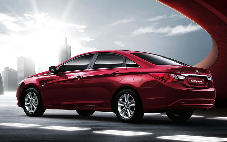 Sleek Hyundai Sonata Driving On An Open Road. Wallpaper