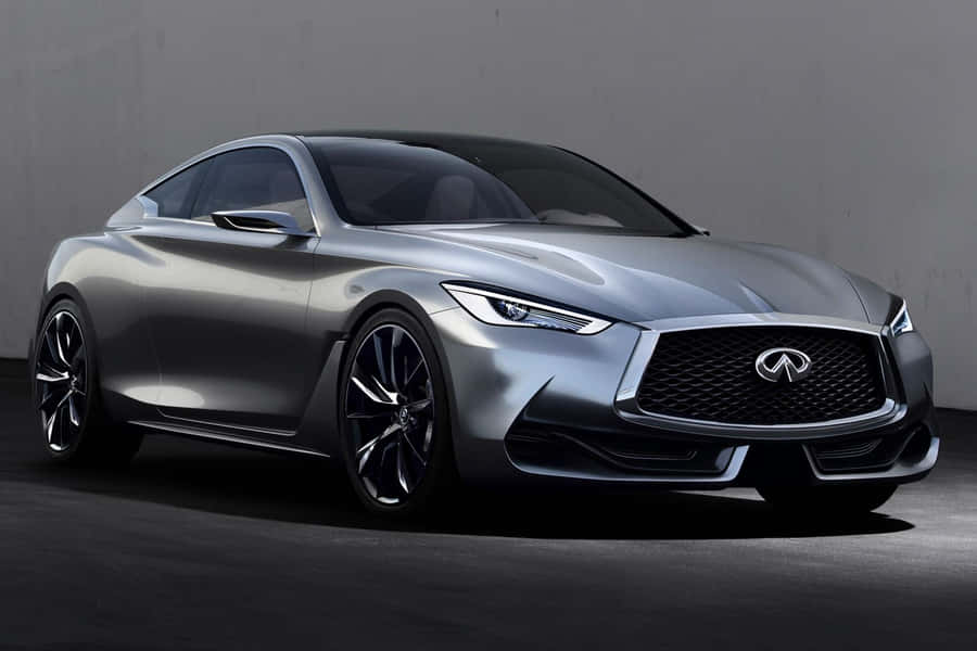 Sleek Infiniti Q60 Cruising Down A Winding Road Wallpaper