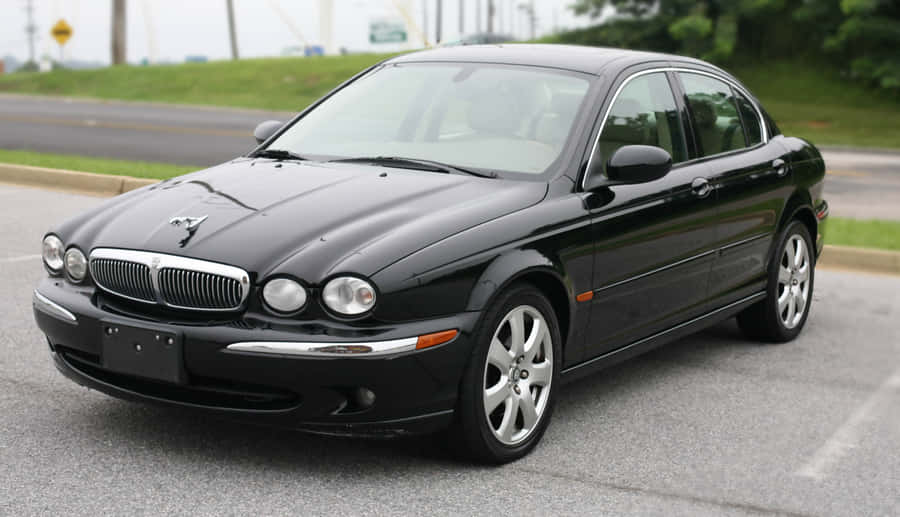 Sleek Jaguar X-type On An Open Road Wallpaper