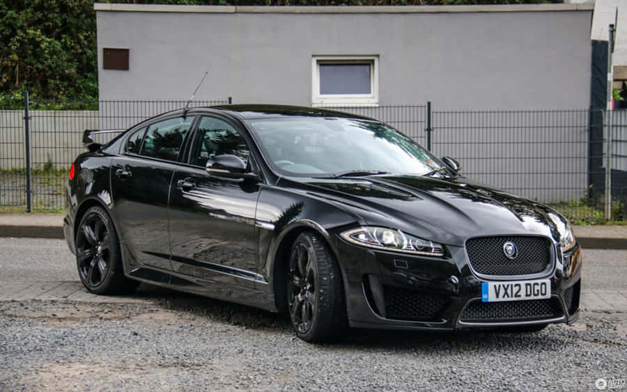 Sleek Jaguar Xfr In Motion On The Open Road Wallpaper
