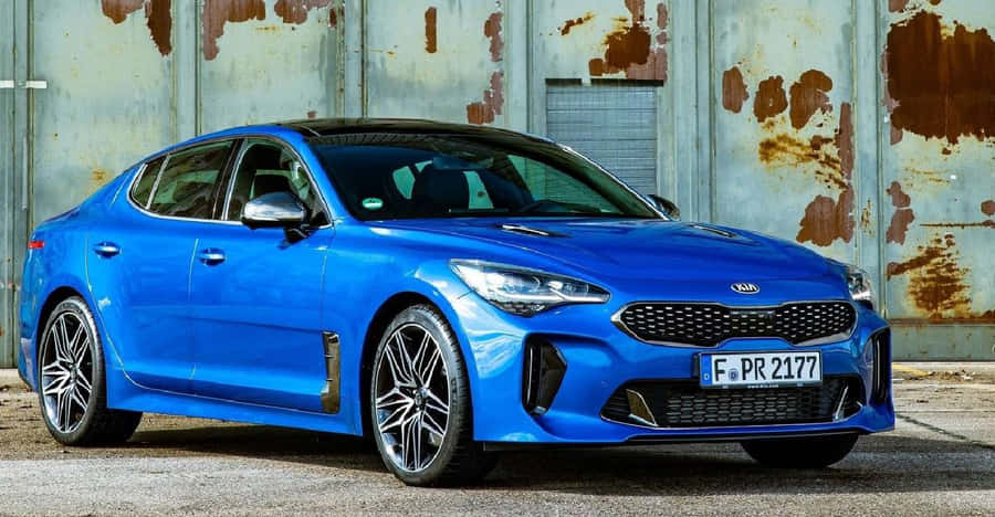 Sleek Kia Stinger In Motion Wallpaper