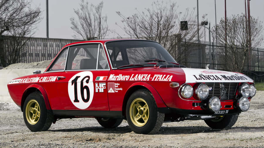 Sleek Lancia Car On A City Street Wallpaper