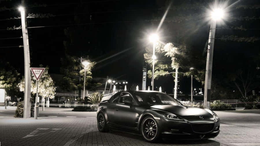 Sleek Mazda Rx-8 Sports Car On The Open Road Wallpaper