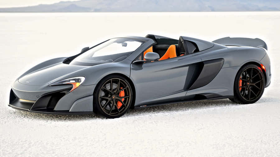 Sleek Mclaren 675lt Spider In Motion Wallpaper