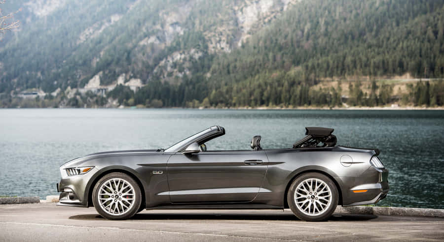 Sleek Midnight Blue Ford Mustang Gt Convertible In Urban Landscape Wallpaper