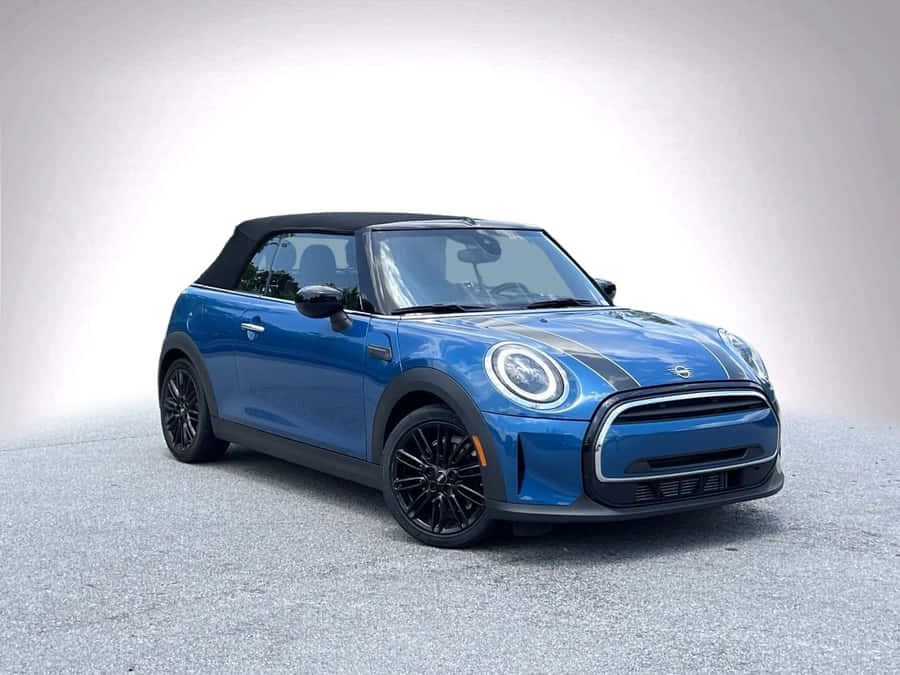 Sleek Mini Cooper Convertible Cruising On The Open Road Wallpaper