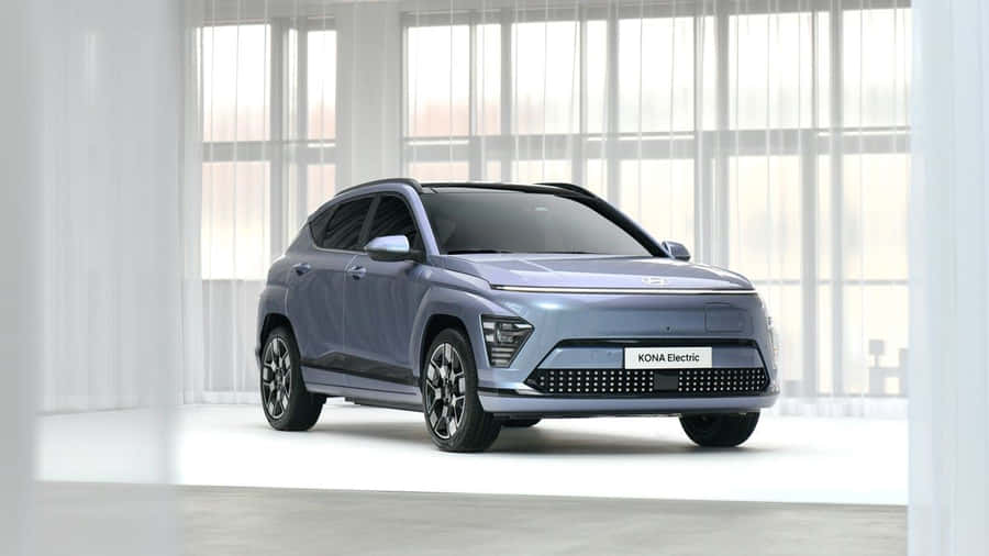 Sleek, Modern Electric Vehicle At Charging Station Wallpaper