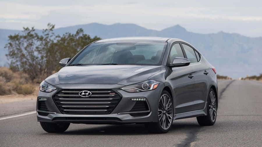 Sleek New Hyundai Elantra On A Scenic Highway Wallpaper