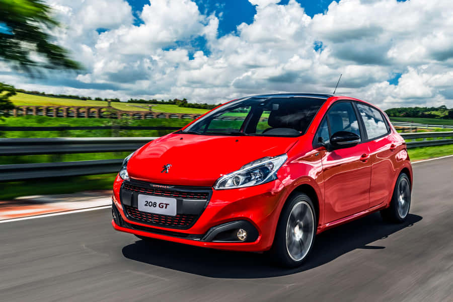 Sleek Peugeot 208 On Urban Road Wallpaper