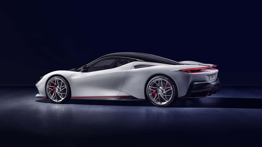 Sleek Pininfarina Sports Car On Asphalt Road Wallpaper