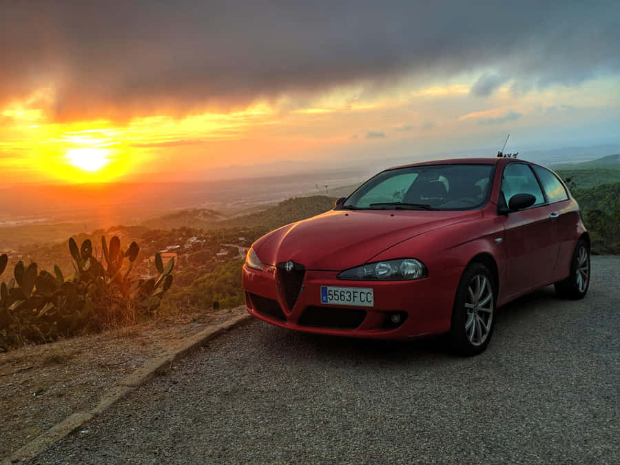 Sleek Red Alfa Romeo 147 In A Stunning Urban Setting Wallpaper