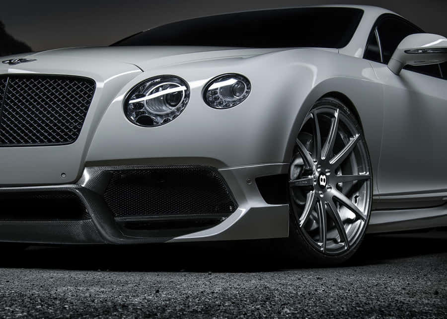 Sleek Red Convertible Cruising On A Scenic Road Wallpaper