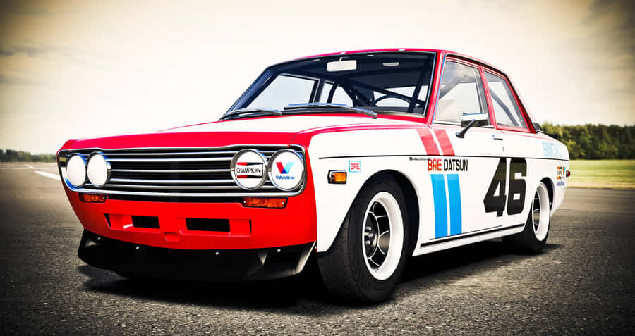 Sleek Red Datsun On A Scenic Road Wallpaper