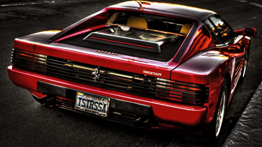 Sleek Red Ferrari Testarossa On Open Road Wallpaper