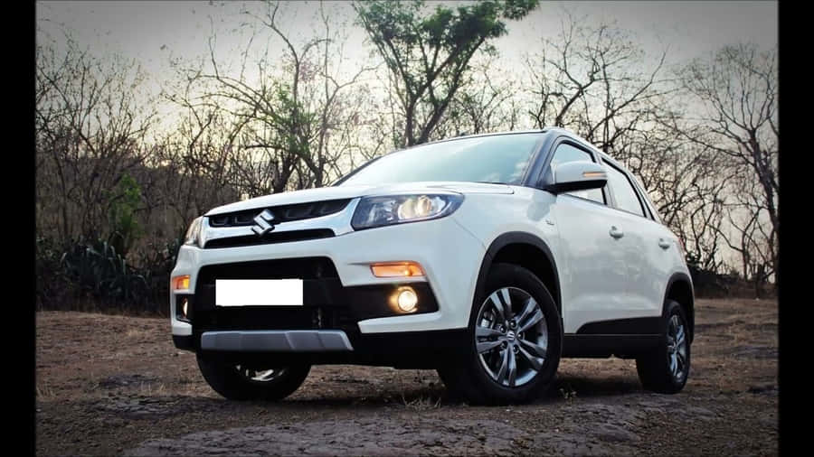 Sleek Red Sports Car In Motion On A Picturesque Road Wallpaper