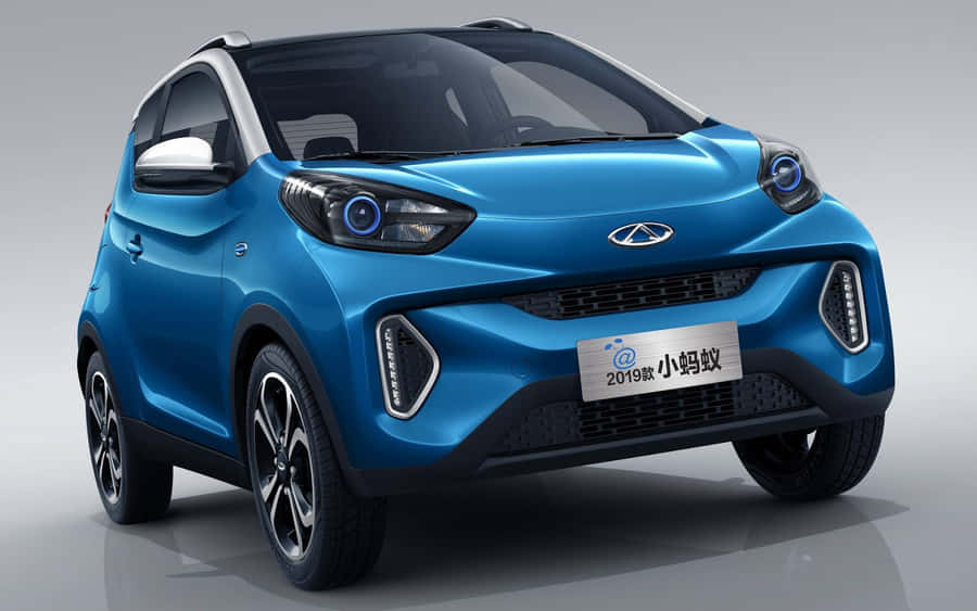 Sleek Silver Chery Automobile Cruising On Open Road Wallpaper