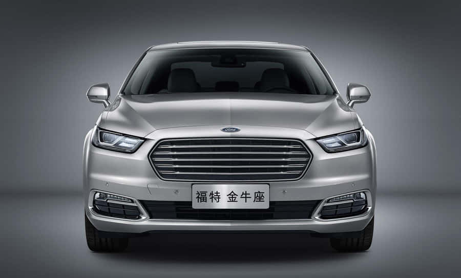 Sleek Silver Ford Taurus On The Road Wallpaper