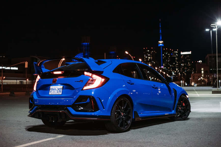 Sleek Silver Hatchback Parked By The River Wallpaper