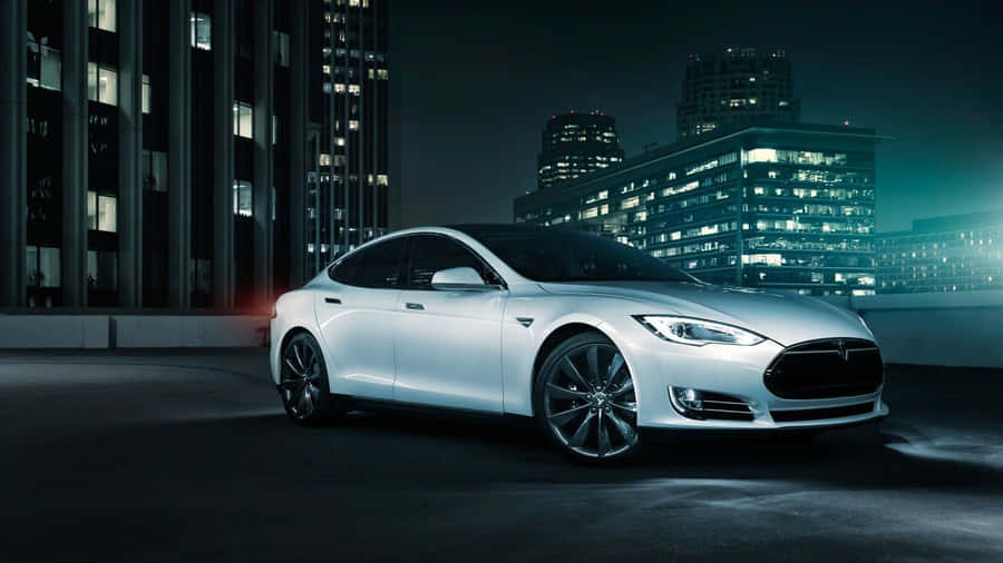 Sleek Silver Hybrid Car On The Road At Sunset Wallpaper