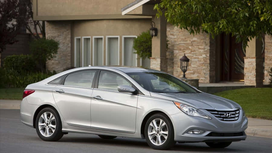 Sleek Silver Hyundai Sonata Parked On Asphalt Road Wallpaper