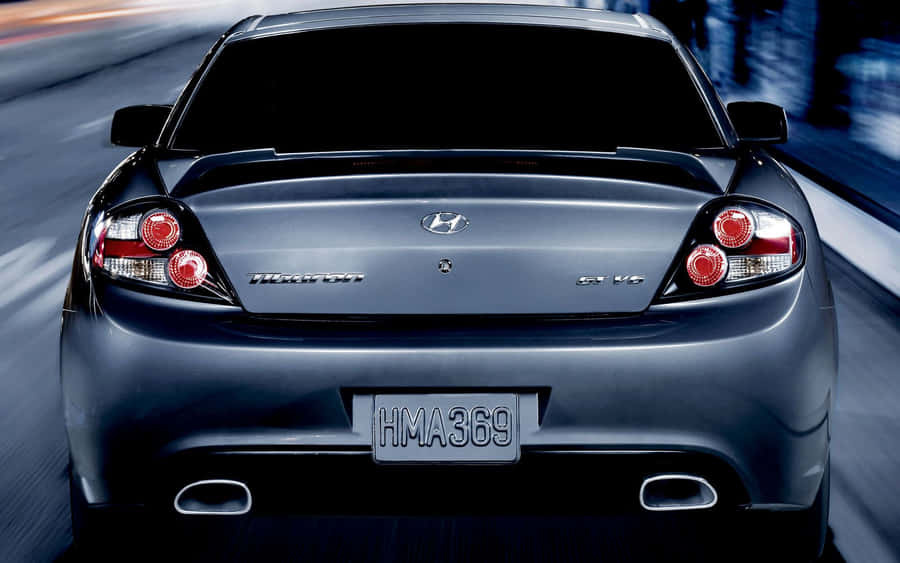 Sleek Silver Hyundai Tiburon On The Open Road Wallpaper