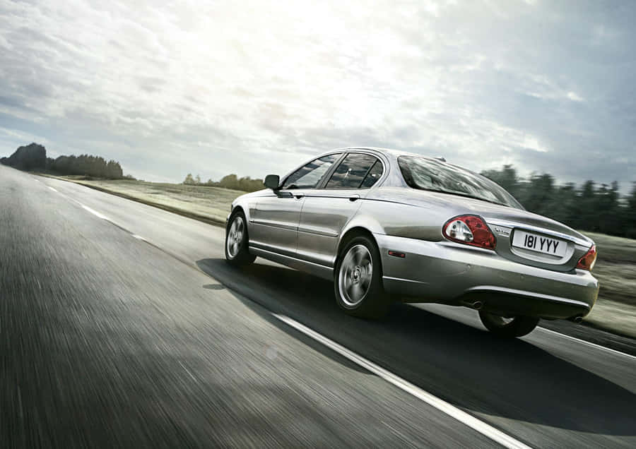 Sleek Silver Jaguar X-type On The Road Wallpaper