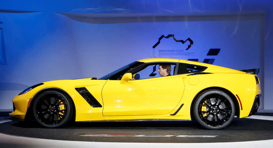 Sleek Sports Car In A Stunning Landscape Wallpaper