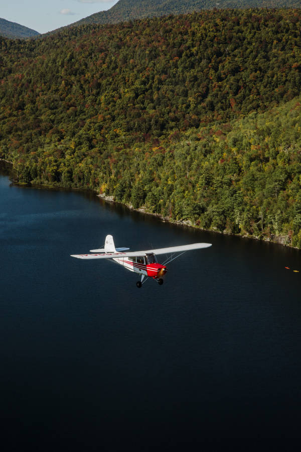 Small Plane Over The Ocean Wallpaper