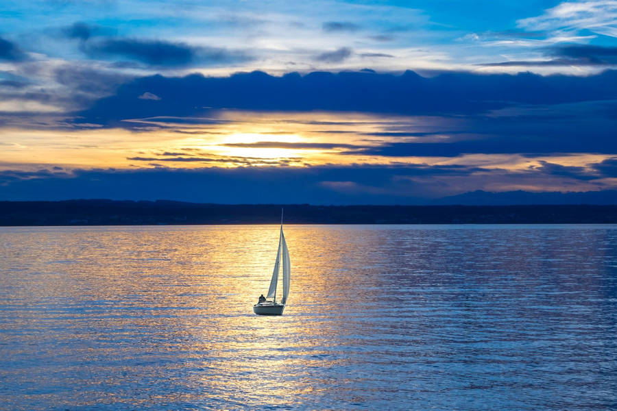 Small Sailing Boat At Dusk Wallpaper