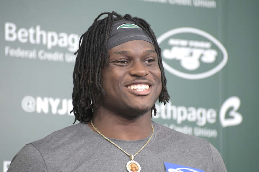 Smiling Football Playerat Press Conference Wallpaper