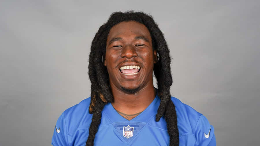 Smiling Football Playerin Blue Jersey Wallpaper