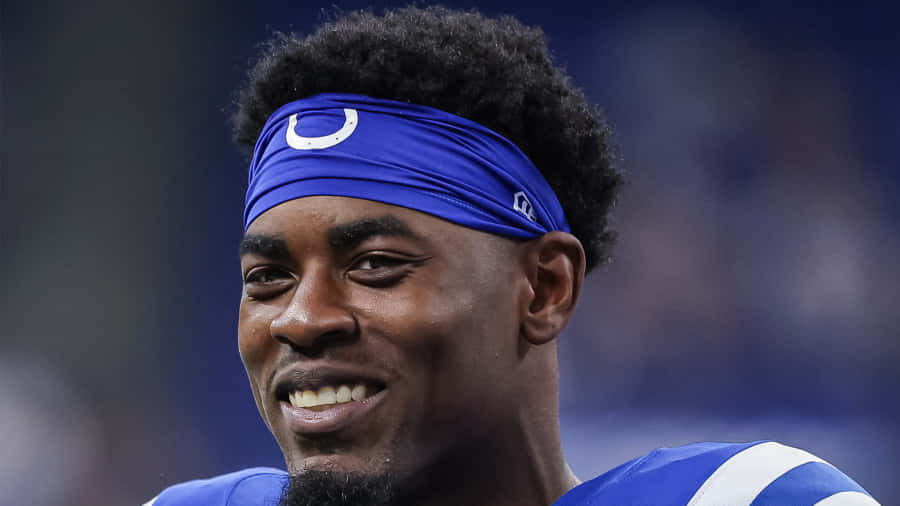 Smiling Football Playerin Blue Uniform Wallpaper