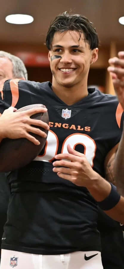 Smiling Football Playerin Locker Room Wallpaper