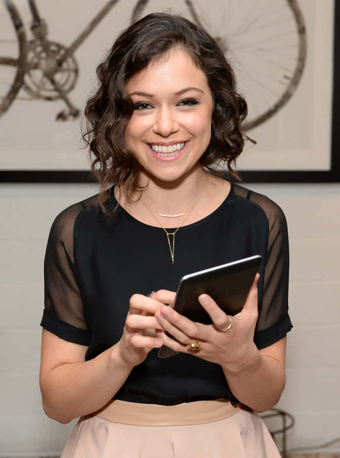 Smiling Woman Holding Tablet Wallpaper