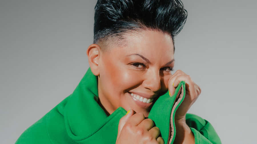 Smiling Womanin Green Coat Wallpaper